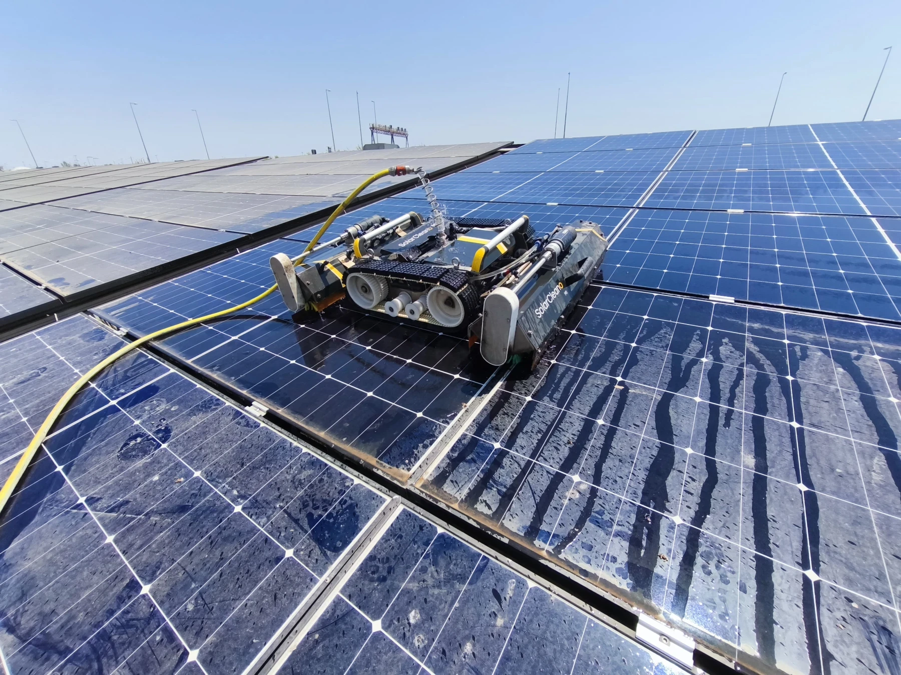 Large-scale industrial PV cleaning with remote-controlled robot.